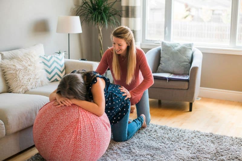 Woman supporting a woman in labor in living room